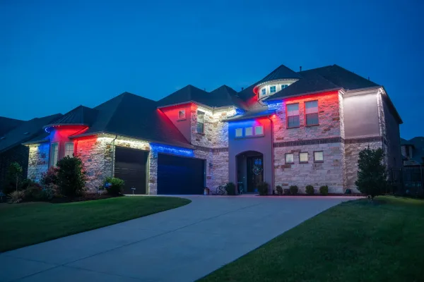 Two story home with permanent Bosso Smart Lighting in patriotic red white and blue colors
