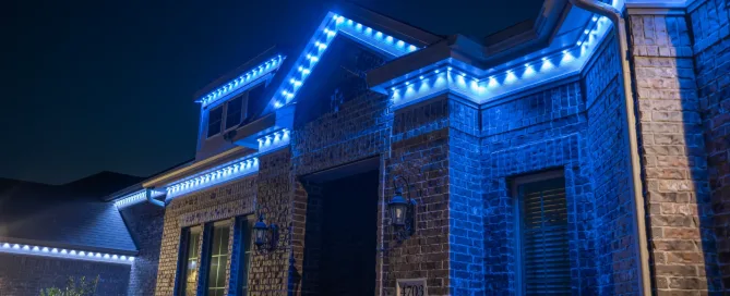 Full blue roofline lighting on brick home from Bosso