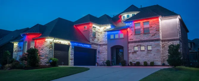 Two-story home with permanent Bosso Smart Lighting in patriotic red, white, and blue colors